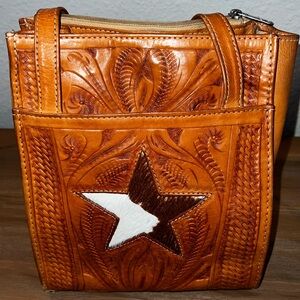Tooled leather bag with hair on hide Star